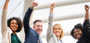 4 people raising hands with smile.