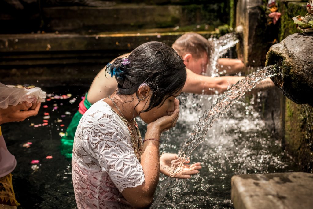 woman drinking water from fountain