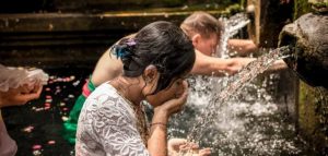 woman drinking water from fountain