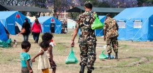 Nepal army distributing food in earthquake relief cap